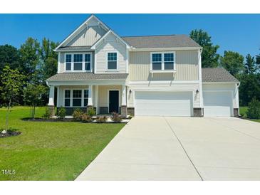 Two-story home with two car garage and landscaping at 91 Walker Grove Ln, Lillington, NC 27546