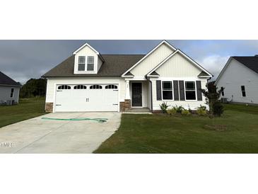 Newly built two-story home with white siding and a two-car garage at 72 Scotties Ridge Dr, Princeton, NC 27569