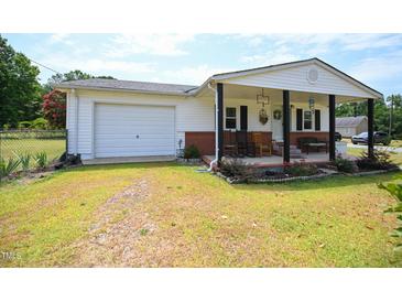 Front view of charming ranch home with covered porch at 101 Mulberry Ln, Dunn, NC 28334