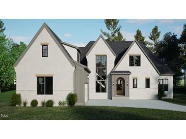 Modern two-story home with gray and white brick exterior, a three car garage, and landscaped front yard at 708 Catawba St, Raleigh, NC 27609