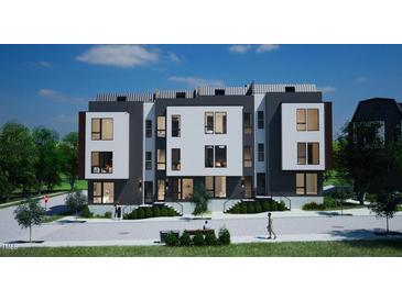 Modern three-story townhome building with dark gray and white exterior and landscaping at 512 Gordon St # 407, Durham, NC 27701