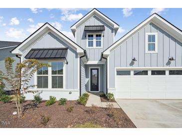 Two-story craftsman style home with gray siding, white trim, and a two-car garage at 420 White Mulberry Ln, Holly Springs, NC 27540