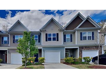 Three-unit townhouse exterior with two-car garage at 3635 Water Mist Ln, Raleigh, NC 27604