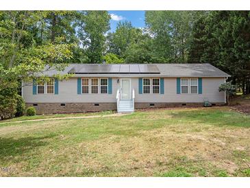 Single-story home with solar panels and landscaped yard at 1510 Logan St, Durham, NC 27704