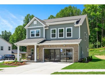 Two-story home with gray siding, brick accents, and a two-car garage at 226 Beacon Dr, Pittsboro, NC 27312