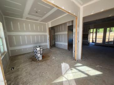 Empty dining room under construction with drywall and subfloor at 6052 Scalybark, Durham, NC 27712