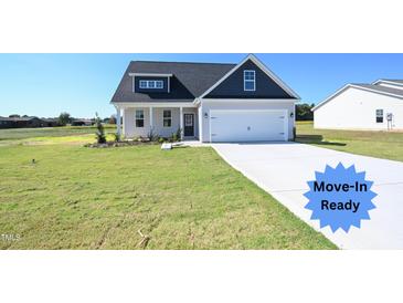 Move-in ready home with gray siding, blue accents, and a two-car garage at 123 Johnson Ridge Way, Four Oaks, NC 27524