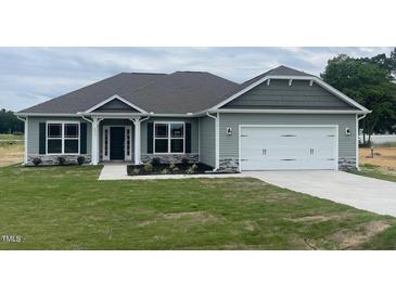 Charming one-story house with gray siding and a two-car garage at 90 Watermelon Dr, Franklinton, NC 27525