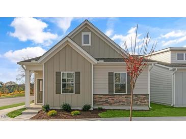 Craftsman style home with gray siding, stone accents, and a welcoming front porch at 723 Dorset Stream Dr, Fuquay Varina, NC 27526
