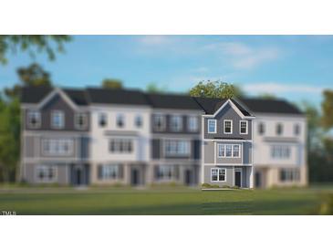 Modern three-story townhome with gray siding at 722 Dorset Stream Dr, Fuquay Varina, NC 27526