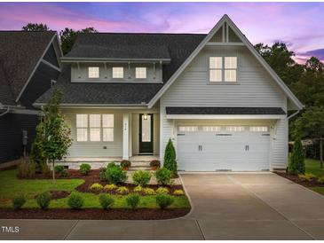 Two story home with white siding and a two car garage at 414 S Cross St, Youngsville, NC 27596