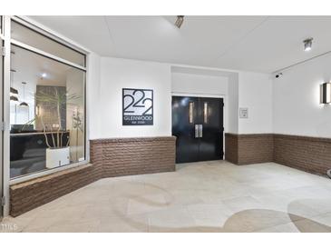 Modern building entrance with stylish double doors at 222 Glenwood Ave # 307, Raleigh, NC 27603