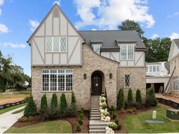 Two-story brick home with a front porch and landscaping at 2646 Marchmont St, Raleigh, NC 27608