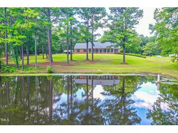 Ranch home on a large lot with a pond in the front at 8246 Us-401, Fuquay Varina, NC 27526