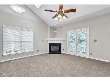 Bright living room featuring a fireplace and access to a balcony at 333 Glenolden Ct, Cary, NC 27513