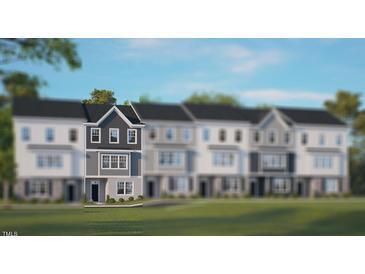 Modern 3-story townhome with gray siding and white accents at 752 Dorset Stream Dr, Fuquay Varina, NC 27526
