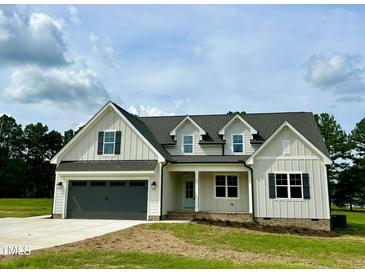 Two-story farmhouse with gray exterior and landscaping at 0 Will Suitt Rd, Butner, NC 27522