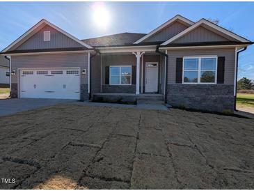 New construction home features gray siding, stone accents, and a two-car garage at 639 Sweet Potato Lane # 3, Nashville, NC 27856