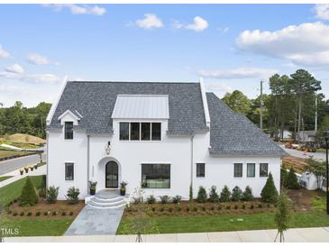 Stunning two-story home with white exterior and gray roof at 3300 Founding Place, Raleigh, NC 27612
