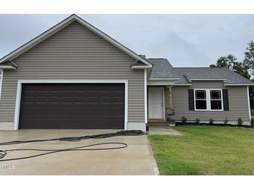 New home with two-car garage and landscaping at 83 Oakfield Trace Dr, Four Oaks, NC 27524