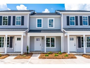 Three-unit townhome building with gray siding and black shutters at 98 Linda St, Princeton, NC 27569