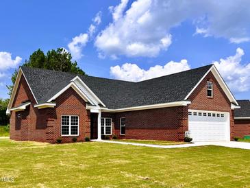 Brick ranch home with two-car garage and green lawn at 3701 Greystone Dr, Rocky Mount, NC 27804