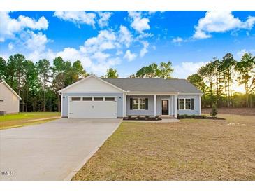 Ranch style home with two-car garage and nice front yard at 9415 Bear Run Ln, Middlesex, NC 27557