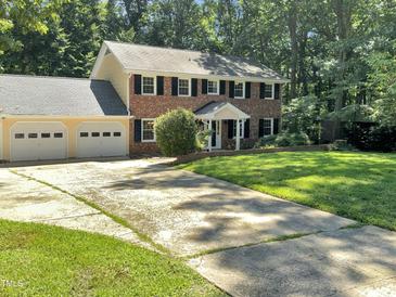 Brick house with three car garage and large yard at 4808 Connell Dr, Raleigh, NC 27612