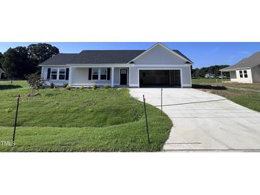 Newly built home with a one car garage and front yard at 138 Lotus Ave, Smithfield, NC 27577