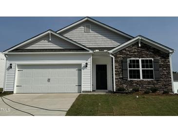 Two-story home with stone accents and attached garage at 2209 Fletchers Ridge Dr, Durham, NC 27703