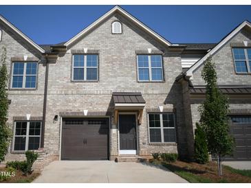 Brick front of two-story townhome with two-car garage at 1027 Bonanza Ln # 31, Mebane, NC 27302