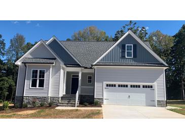 One-story house with gray siding, gray roof, and a two-car garage at 35 Courtland Dr, Louisburg, NC 27549