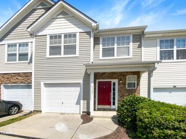 Attractive two-story townhome with a red front door and attached garage at 5107 Sandy Banks Rd, Raleigh, NC 27616