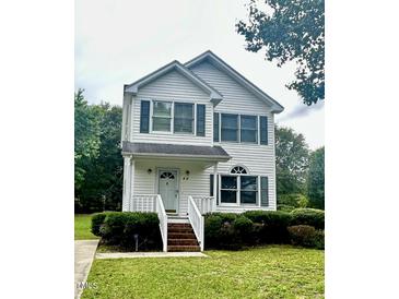 Two story house with manicured lawn at 44 Wallace St, Angier, NC 27501