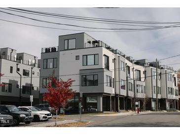 Modern townhouses with sleek gray siding and rooftop decks at 3005 Corbell Rd, Durham, NC 27701