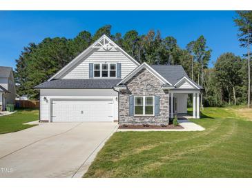 Two-story home with stone accents and a two-car garage at 121 Valleydale Dr, Benson, NC 27504