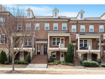 Brick three-story townhome with front porch at 836 Bankston Woods Way, Raleigh, NC 27609