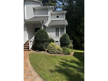 White two story house with brick walkway and landscaping at 492 Beechmast, Pittsboro, NC 27312