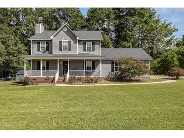 Two-story gray house with a large front yard at 1001 Yopon Ct, Raleigh, NC 27603