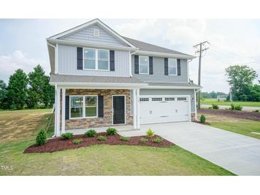 Two-story home with gray siding, stone accents, and a two-car garage at 98 Kipling Creek Dr, Fuquay Varina, NC 27526