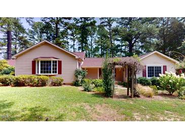 Ranch home with a well-manicured lawn and mature trees at 5141 Nc 56, Franklinton, NC 27525