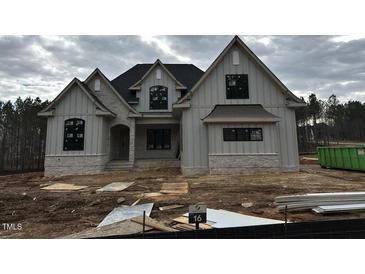 Modern farmhouse style home with stone and siding exterior at 30 Spanish Oak Dr, Youngsville, NC 27596