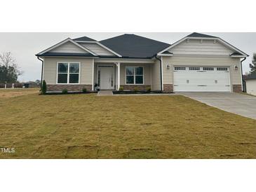 New construction home with a two-car garage and landscaped lawn at 677 Sweet Potato Lane # 1, Nashville, NC 27856