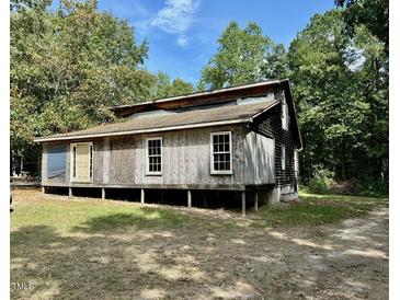 Rustic one-story home with wooden siding needing some repairs at 255 Roberts Ave, Henderson, NC 27537