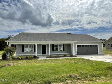 One story home with a two-car garage and covered porch at 170 Lotus Ave, Smithfield, NC 27577