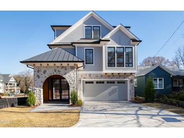 Modern two-story home with stone accents, a metal roof, and a paved driveway at 1610 Carson St, Raleigh, NC 27608
