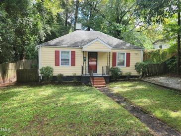 Charming yellow house with red shutters and a well-maintained lawn at 1202 N Duke St, Durham, NC 27701