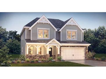 Two-story house with gray siding, stone accents, and a two-car garage at 1110 Jersey St, Haw River, NC 27258