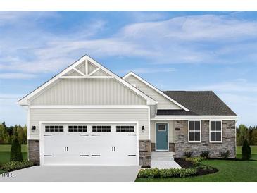 Two story house with a two-car garage and stone accents at 8810 Kenridge Ln, Fuquay Varina, NC 27526