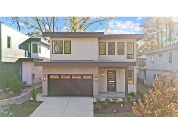 Modern two-story home with a dark gray garage door and light beige exterior at 2313 Turners Aly, Raleigh, NC 27607